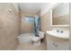 Bright bathroom with tiled walls, tub and shower combination, and a vanity with storage at 1209 Marygon St, Kissimmee, FL 34744