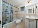 Cozy bathroom with bathtub, tiled walls, and a classic vanity at 1209 Marygon St, Kissimmee, FL 34744