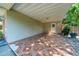 Open carport featuring tile flooring and access door, perfect for parking and additional covered space at 1209 Marygon St, Kissimmee, FL 34744