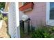 Exterior view of a water filtration system attached to the house in the side yard at 1209 Marygon St, Kissimmee, FL 34744