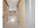 Hallway with tile flooring and white closet doors at 1209 Marygon St, Kissimmee, FL 34744