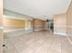 Bright living room with neutral walls, tile flooring, and mirror accent wall at 1209 Marygon St, Kissimmee, FL 34744