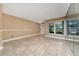 Bright living room with neutral walls, tile flooring, and large windows at 1209 Marygon St, Kissimmee, FL 34744