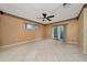 Bright living room with tile flooring, ceiling fan, and sliding glass doors to bring the outdoors in at 1209 Marygon St, Kissimmee, FL 34744
