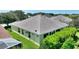 Aerial view of the backyard with mature landscaping, a well maintained lawn, and the back of the single story house at 1258 Donalds Pl, The Villages, FL 32162
