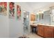 Bathroom featuring floral artwork, single vanity with a makeup area, and toilet in a separate area at 1258 Donalds Pl, The Villages, FL 32162
