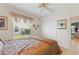 Bedroom featuring a ceiling fan, closet, carpeted floors, and natural light from a window at 1258 Donalds Pl, The Villages, FL 32162