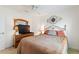 Bedroom with dresser, TV, metal headboard, ceiling fan, and decorative wall art at 1258 Donalds Pl, The Villages, FL 32162