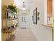 Inviting entryway featuring tiled floors, decorative shelving, and a view to the interior spaces at 1258 Donalds Pl, The Villages, FL 32162