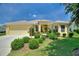 Charming single-story home with a well-manicured front yard, mature landscaping, and an attached two-car garage at 1258 Donalds Pl, The Villages, FL 32162