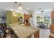 Modern kitchen with granite countertops, stainless steel appliances, and a breakfast bar with seating at 1258 Donalds Pl, The Villages, FL 32162
