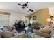 Living room featuring wood floors, ceiling fans, comfortable seating, and neutral decor at 1258 Donalds Pl, The Villages, FL 32162