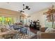 Comfortable living room featuring ceiling fans, wood floors and neutral tones at 1258 Donalds Pl, The Villages, FL 32162
