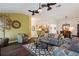 Bright living room features ceiling fans, wood floors and opens to the kitchen and dining area at 1258 Donalds Pl, The Villages, FL 32162