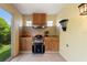 An outdoor kitchen with stainless steel grill, tiled backsplash, cabinets, and adjacent to the outdoor living area at 1258 Donalds Pl, The Villages, FL 32162