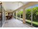 Wide patio area with multiple ceiling fans, table set, and multiple sliding glass doors to connect to the yard at 1258 Donalds Pl, The Villages, FL 32162