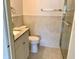 Bathroom featuring a white vanity, granite countertop, and a glass enclosed shower at 1309 N Thacker Ave, Kissimmee, FL 34741