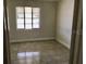 The bedroom has a large window and neutral walls allowing for customized decor at 1309 N Thacker Ave, Kissimmee, FL 34741
