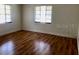 Bright bedroom featuring hardwood floors and natural light streaming through the large windows at 1309 N Thacker Ave, Kissimmee, FL 34741