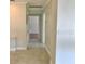 Hallway featuring neutral walls and tile flooring that enhances flow throughout the property's design at 1309 N Thacker Ave, Kissimmee, FL 34741