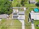 Aerial shot of a house with solar panels, a fenced backyard, above ground pool and long driveway at 1408 Polk City Rd, Haines City, FL 33844