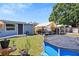 Backyard with an above-ground pool, covered car, and well-maintained lawn at 1408 Polk City Rd, Haines City, FL 33844
