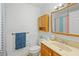 Bathroom with a single sink vanity, blue accents, and a medicine cabinet mirror at 1408 Polk City Rd, Haines City, FL 33844