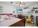 Bright bedroom with a ceiling fan, wood furniture, and decorations at 1408 Polk City Rd, Haines City, FL 33844