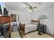 Cozy bedroom with neutral colors, wood furniture, and a ceiling fan at 1408 Polk City Rd, Haines City, FL 33844