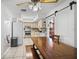 Spacious kitchen with a center island, stainless steel appliances, and a large dining table at 1408 Polk City Rd, Haines City, FL 33844