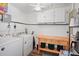 Functional laundry area with washer, dryer, storage cabinets, and countertop at 1408 Polk City Rd, Haines City, FL 33844