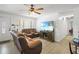 A bright living room with a large TV, comfortable furniture, and natural light from the window at 1408 Polk City Rd, Haines City, FL 33844