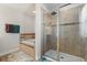 Well-lit bathroom featuring a glass-enclosed shower and a soaking tub at 152 Whirlaway Dr, Davenport, FL 33837