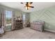 Bedroom featuring a crib, large windows, and neutral décor at 152 Whirlaway Dr, Davenport, FL 33837