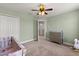 Cozy Bedroom featuring a crib, a dresser, and neutral décor at 152 Whirlaway Dr, Davenport, FL 33837