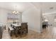 Bright dining area with a wooden dining table and wood flooring. Open concept flows to kitchen at 152 Whirlaway Dr, Davenport, FL 33837