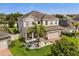 Well-maintained two-story home with lush landscaping, a side-entry garage, and a beautiful front yard at 152 Whirlaway Dr, Davenport, FL 33837