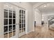 Inviting foyer featuring tile floors, and white framed french doors leading to a flex space at 152 Whirlaway Dr, Davenport, FL 33837