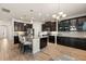 Spacious kitchen featuring dark cabinets, stainless steel appliances, and a center island with bar seating at 152 Whirlaway Dr, Davenport, FL 33837