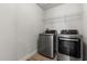 The laundry room features modern appliances and convenient overhead shelving for storage at 152 Whirlaway Dr, Davenport, FL 33837