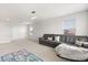 Second living room view showcasing comfortable seating, natural light, and carpet flooring at 152 Whirlaway Dr, Davenport, FL 33837