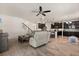 Open floor plan of the living room and kitchen, featuring tile floors and dark cabinets at 152 Whirlaway Dr, Davenport, FL 33837