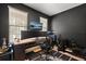 A stylish home office features a sleek desk setup, modern decor, and ample natural light at 152 Whirlaway Dr, Davenport, FL 33837