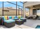 Covered patio featuring comfortable outdoor seating and dining area, perfect for entertaining at 152 Whirlaway Dr, Davenport, FL 33837