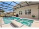 Screened-in pool and hot tub area with outdoor seating, creating a relaxing backyard oasis at 152 Whirlaway Dr, Davenport, FL 33837