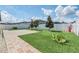 Fully fenced backyard with well-maintained lawn, concrete patio, and lush landscaping at 1602 Steely Dr, Dundee, FL 33838