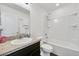 Bathroom featuring modern vanity with granite countertop, shower, and toilet at 1602 Steely Dr, Dundee, FL 33838