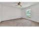 Bright bedroom features neutral carpeting and a large window for ample natural light at 1602 Steely Dr, Dundee, FL 33838