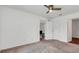 A bright bedroom, with carpet, features two open doorways to other rooms at 1602 Steely Dr, Dundee, FL 33838