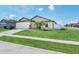 Traditional single-Gathering home offering a lush front lawn and ample street parking for convenient living at 1602 Steely Dr, Dundee, FL 33838